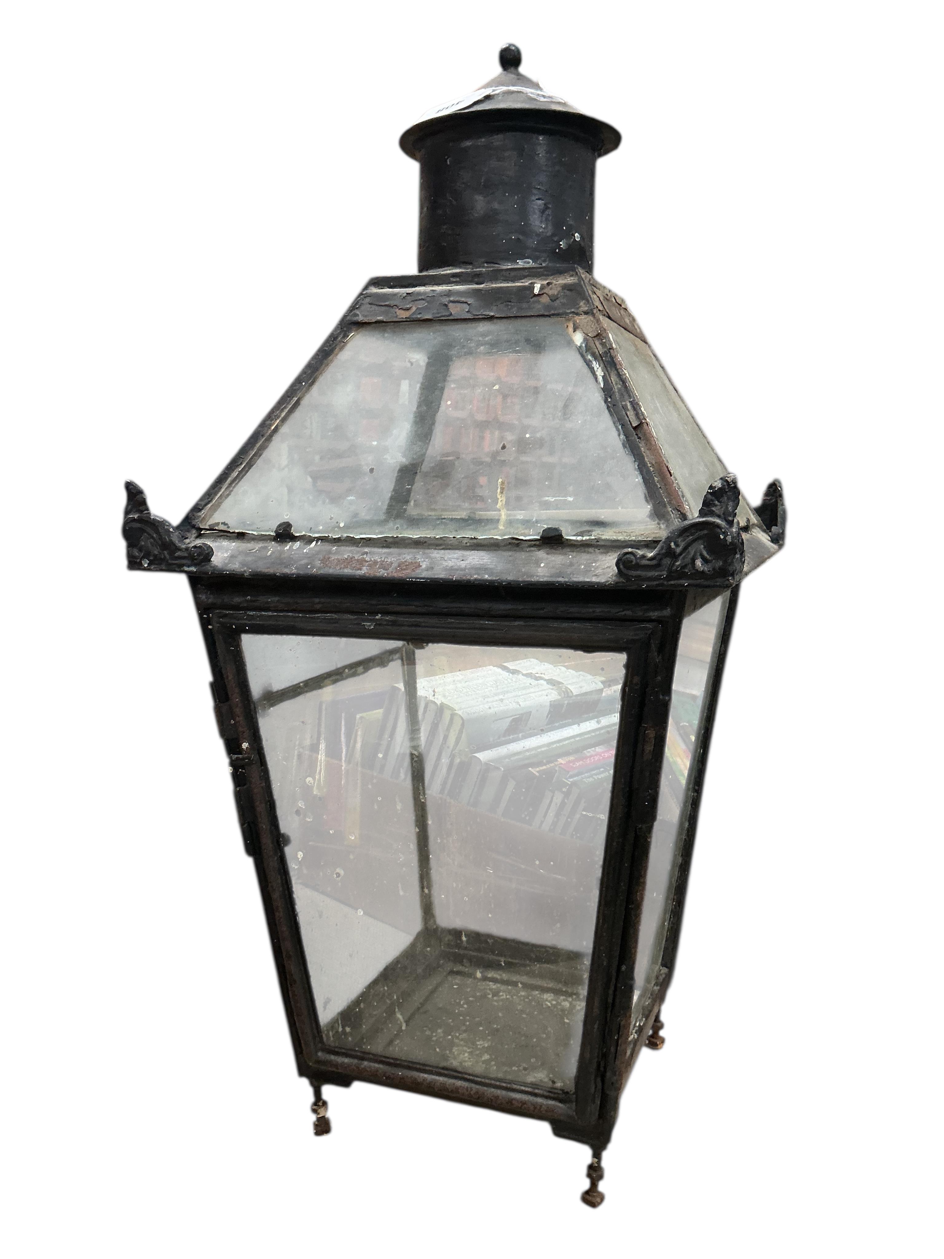 A glass and steel railway station lantern with an opaque glass panel showing the remains of a painted possible station name, missing the burner etc., 80cm high, 40cm wide